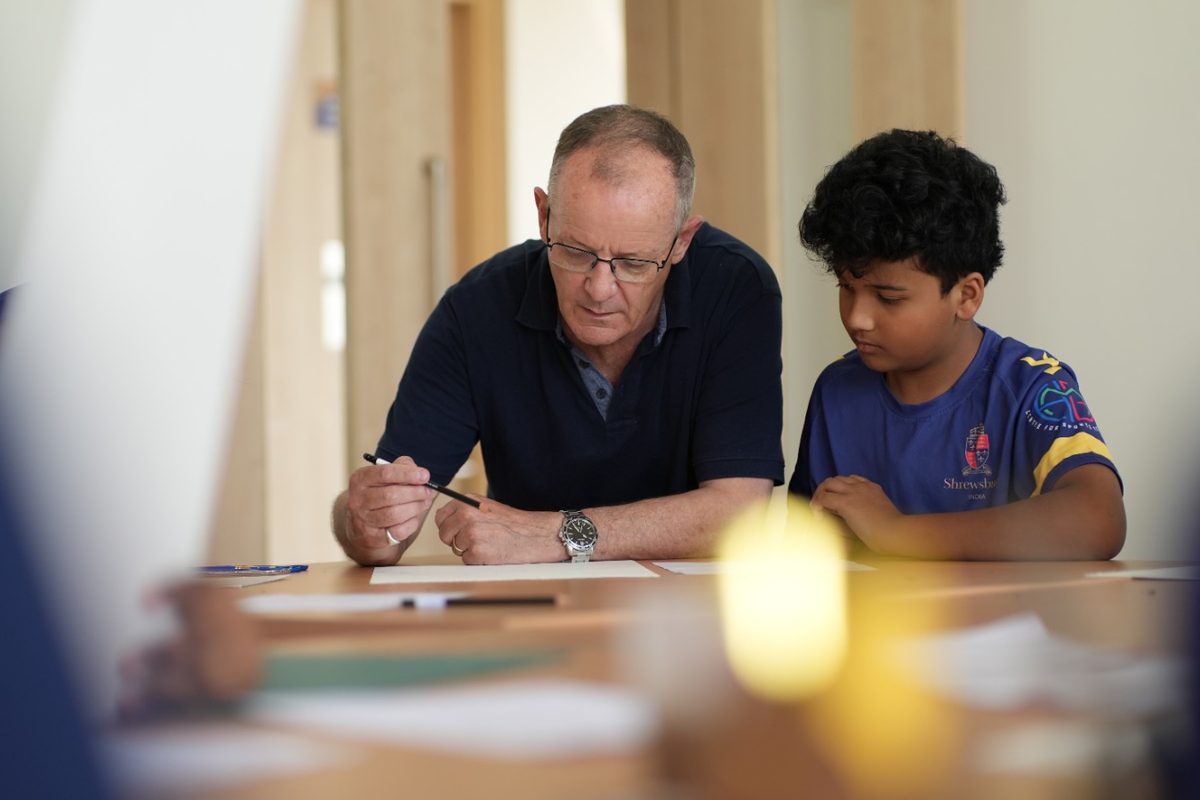 The Headmaster working with a pupil