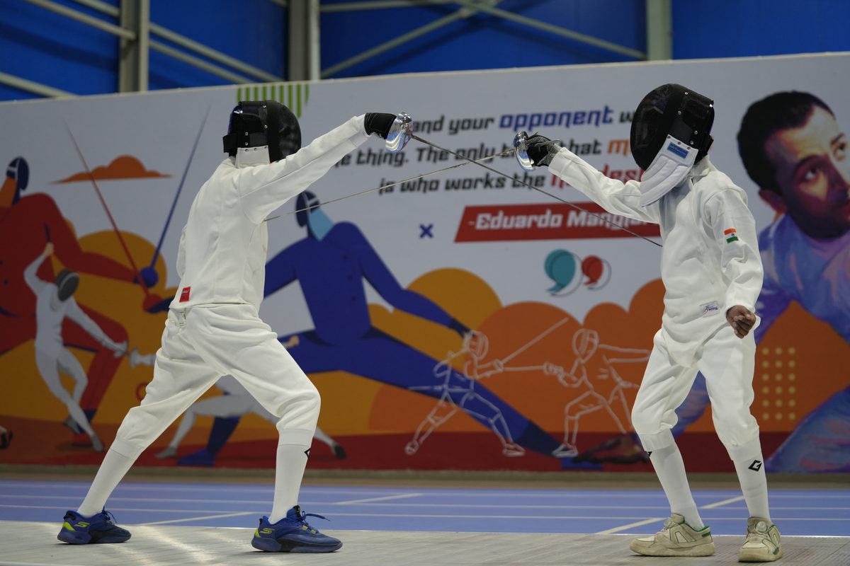 Two pupils fencing in the sports hall